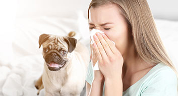 Woman blowing her nose